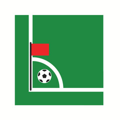 A soccer ball is positioned near a red corner flag on a green soccer field. © Devynee Studio
