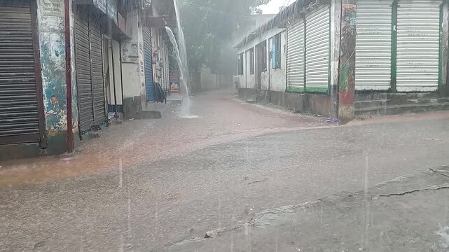 A direct view of the summer torrential rain falling on the street.