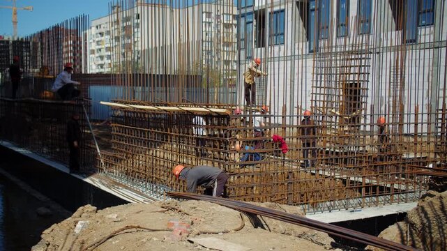 Construction crew working on reinforced concrete foundation