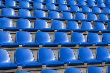 Naklejka premium Abstract background pattern of empty plastic seats rows inside modern outdoor sports stadium grandstand seating