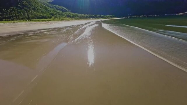 An exhilarating FPV-style drone shot diving down a steep mountainside, dramatically revealing Norway's breathtaking fjords below. The fast-paced aerial movement creates a powerful sense of speed and i