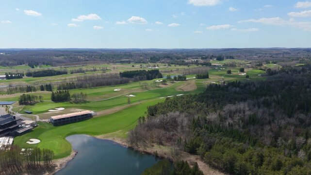 The lush TPC Toronto at Osprey Valley Golf Course with surrounding forests and water features.