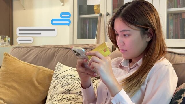 Wide 4K shot of an Asian woman sitting on a living room sofa, holding a credit card and texting on her mobile phone with graphic boxes.