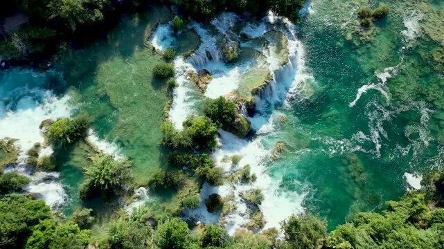 A scenic drone view of the falls reveals the river winding through dense forest in Skradinski Buk Waterfall, Krka National Park, Croatia