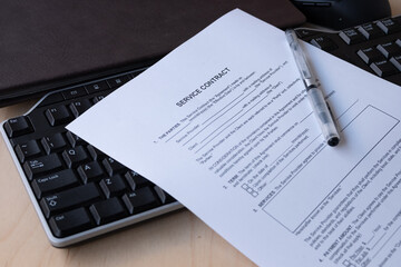 Obraz premium A printed Service Contract form with blank fields for service provider and client details, effective date, term, and parties clauses