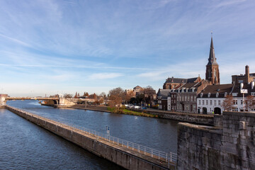 Fototapeta premium Scenic view of the Meuse river and St Martins Church spire in Maastricht