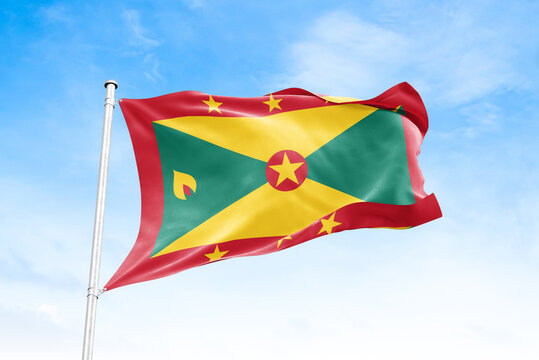 Grenada national flag waving against blue sky