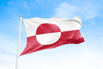 Greenland national flag waving against blue sky © VuongTan