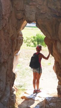 Woman exploring ancient stone ruins in Tiryns, Greece
