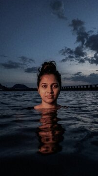 ndian woman taking a holy dip in Krishna River during Maha Shivaratri festival in Vijayawada.