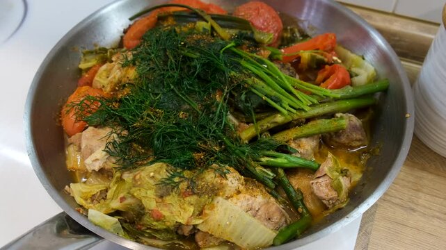 A dish of stewed vegetables in a frying pan. Selective focus.