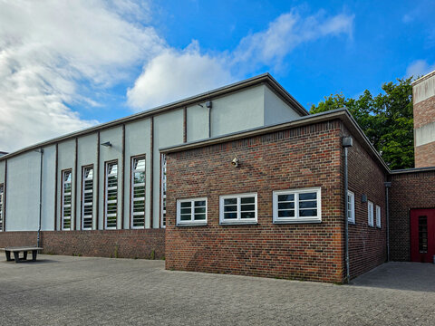 Industrial brick warehouse building with modern architecture under blue sky