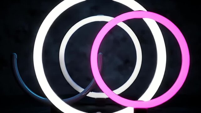 Interlocking white and pink neon light rings.