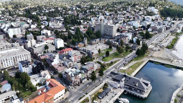 Aerial view of the beautiful alpine city of San Carlos de Bariloche on the shores of Nahuel Huapi Lake, Patagonia, Argentina. The scenic waterfront features a civic center and mountain backdrop.