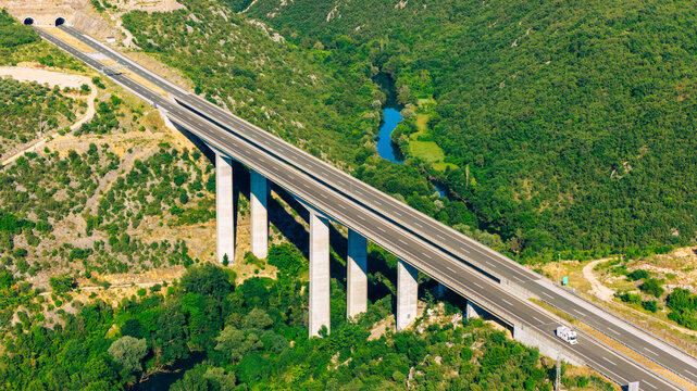 Modern highway bridge crossing a green valley in Herzegovina, captured from above, illustrating contemporary transport infrastructure and regional connectivity
