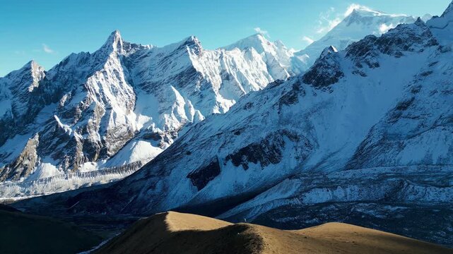 Aerial View of Tiny Hiker on Alpine Ridge with Manaslu Peak and Snow Covered Himalayas in Background, Nepal