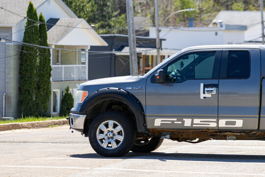 La Tuque, Quebec, 23 May 2026 : A gray Ford F- pickup truck is parked on a street in a residential area.