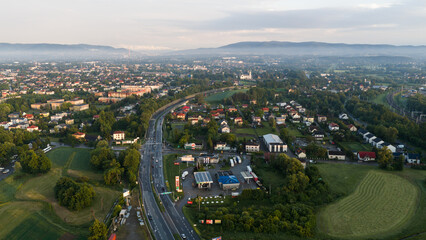 Fototapeta premium Aerial view of Czechowice-Dziedzice city landscape in Silesia, Poland, at sunset with Beskid mountains in the background