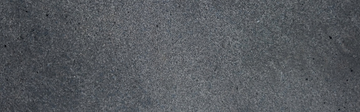 Dark gray concrete texture background, industrial cement wall surface, charcoal stone floor with grainy detail, minimalist slate backdrop for product photography
