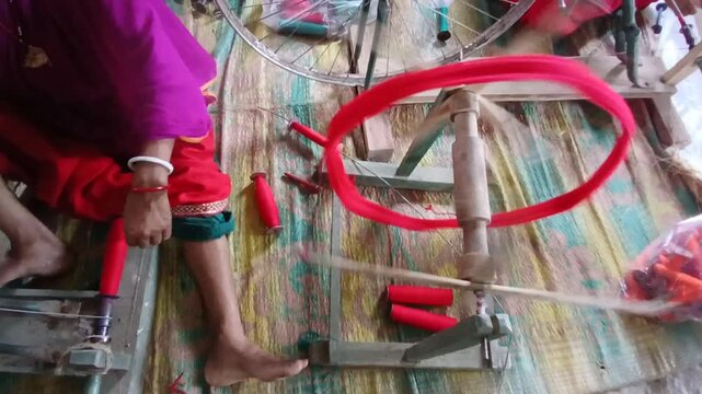 A Handloom Weaver preparing yarns in India.