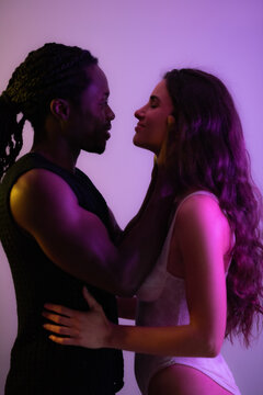 Portrait of young romantic multiracial couple feeling happy. Studio shot