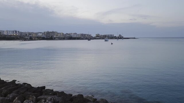 Dusk over the calm sea of ​​Otranto, a tourist town on the Adriatic coast, Italy.