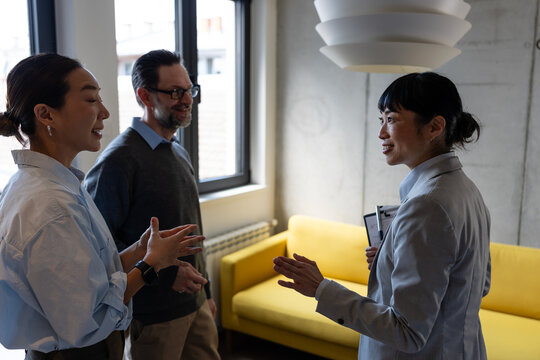 A diverse couple consulting with a real estate professional about purchasing a home. Lifestyle business scene representing trust, investment, and future planning