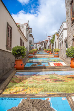 Firgas, Spain  19 May 2025,  The famous tiled staircase in Firgas, Gran Canaria, featuring intricately designed ceramic tiles, traditional terracotta pots, and historic natural stone houses