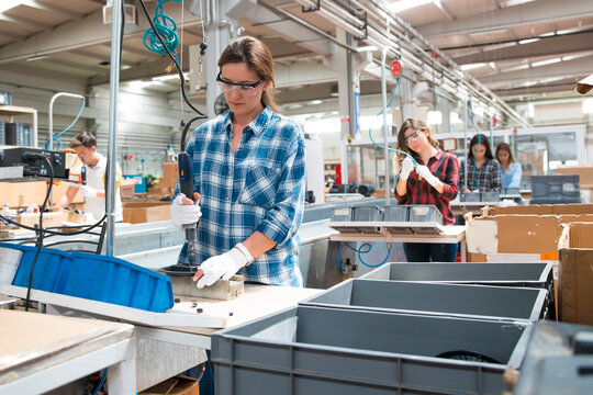 Woman working on an assembly line in a factory