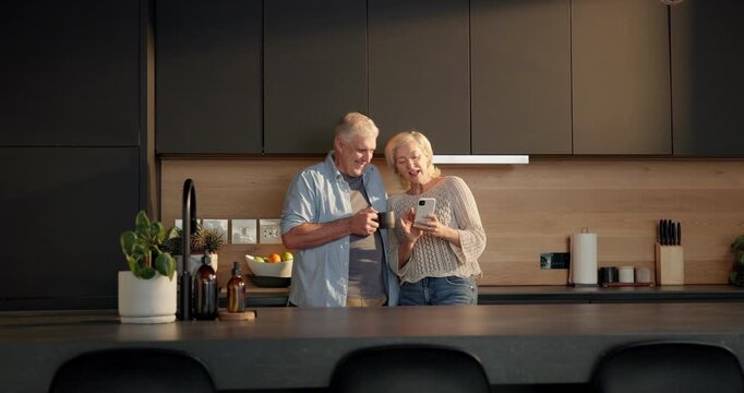 Coffee, phone and elderly couple in home for morning, conversation or laugh together in kitchen. Love, smile and old man with woman for funny joke with social media, retirement and chat in apartment