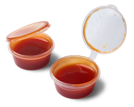 small plastic red tomato sauce containers isolated white background, clear disposable portion cup served along with pizzas, takeaway condiment packaging