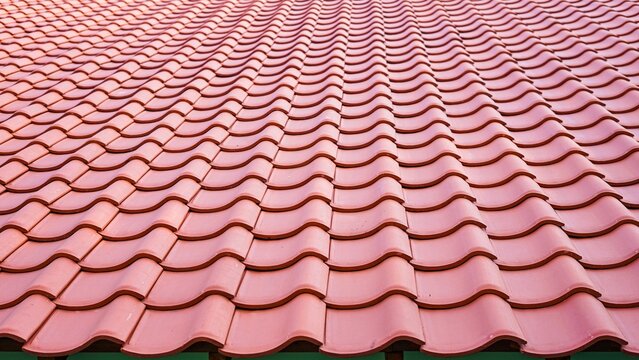 Wavy orange clay roof tiles pattern background in perspective view.