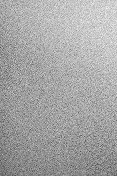 Fine silver metallic glitter texture surface with soft light gradient.
