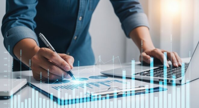 Businessperson analyzing data on laptop with graphs and charts overlay on documents