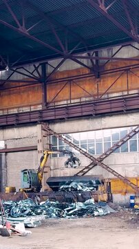 Pile of industrial scrap metal pieces from manufacturing press machine process. Recyclable industrial metal sheet waste from factory press process vertical footage hd
