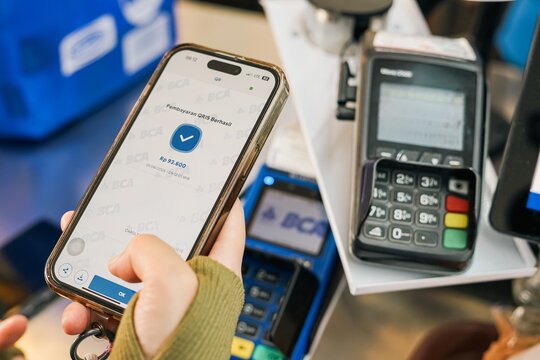 Mobile payment transaction using smartphone and card terminal on June 18, 2026 in Bogor, Indonesia