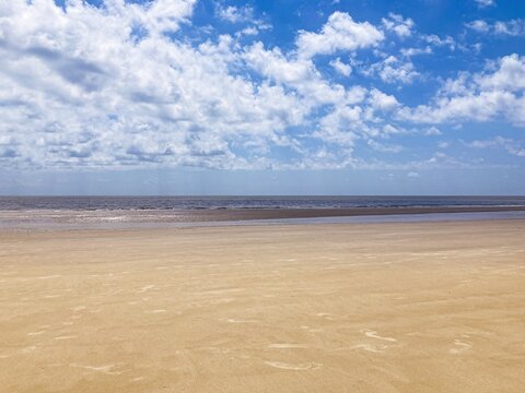 Beach Sand with Ocean and Clouds