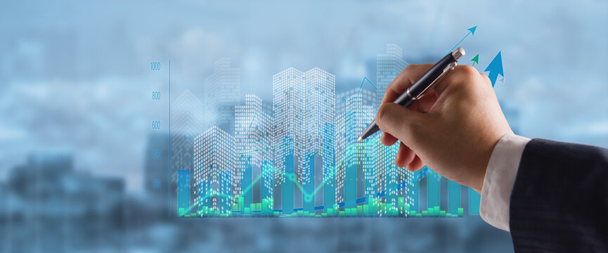 Businessman hand holding pen drawing real estate investment financial chart digital city concept for property development stock market urban planning corporate success and economic growth strategy