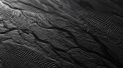 Fototapeta premium Abstract top down view of dark volcanic sand ripples.