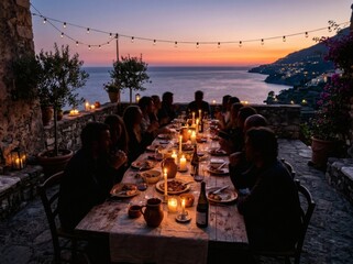 Obraz premium Friends dining outdoors on terrace overlooking sea at sunset.