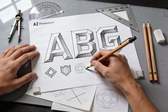 Top view of a branding design process with logo sketches and corporate stationary on desk