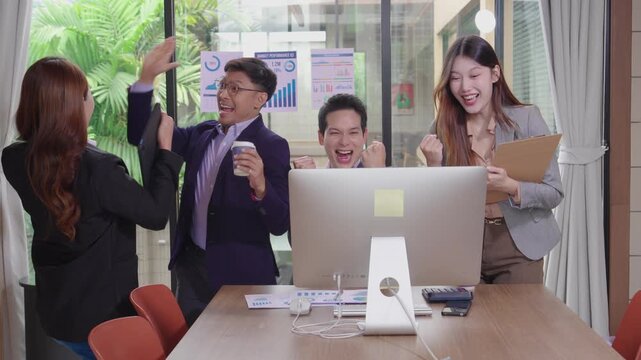 Expressing congratulations on their success, business people smiled and raised their hands in joy, demonstrating the completion of their work and the success of teamwork.