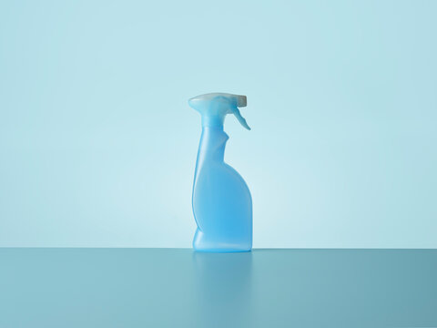 Blue trigger spray against blue background with horizon