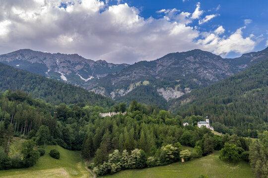 Aerial landscape of the Karwendel mountains with the Romedikirchl pilgrimage chapel and forested foothills near Thaur, Tyrol, Austria