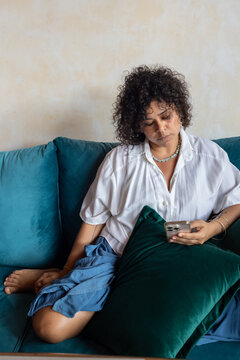 pensive woman using internet on smartphone, reading
