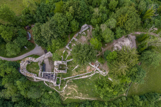 Top-down aerial view of the medieval Burgruine Thaur castle ruin with surviving walls and courtyard, Tyrol, Austria