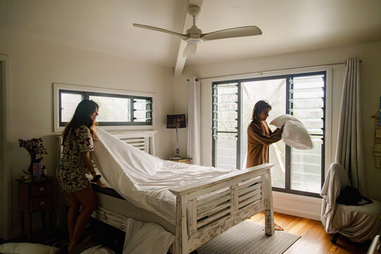 Sisters making bed during cyclone in Northern Rivers