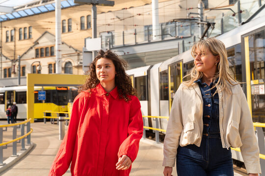 Two Friends Walking at the Train Station 