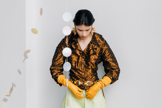 Editorial fashion portrait with bronze satin and bright gloves