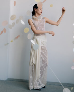 Artistic fashion portrait with sheer gown and pastel decor